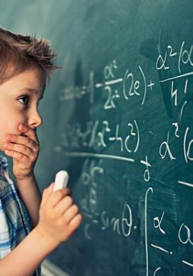 Little boy in math class overwhelmed by the math formula.