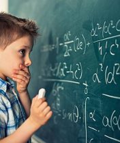 Little boy in math class overwhelmed by the math formula.