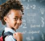 Cute little African school girl in classroom.
